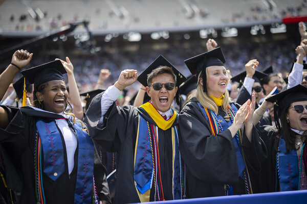 students cheer at the end of commencement