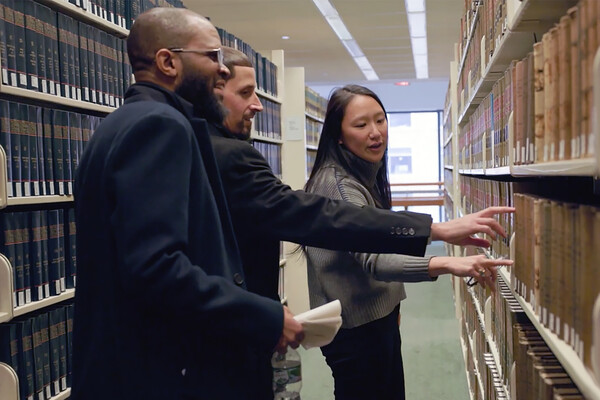 Felicia Lin, right, with Marco Maldonado and Theophalis Wilson (left) in the stacks of the Penn Law Library.