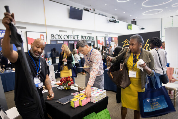 A vendor shows off their products to visitors at the Diversity Supplier Expo.
