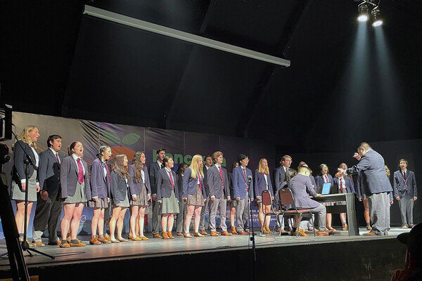 Members of the Pen Glee Club performing on stage.