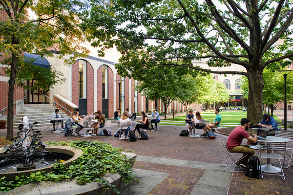 Law students seated outdoors in front of Penn Carey Law.