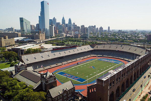 An aerial view of Franklin Field with the Philadelphia Center City skyline in the background.