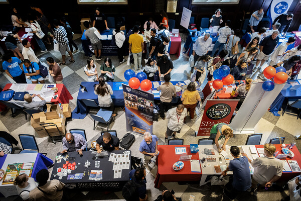 Students walk around the New Student Resources Fair in Houston Hall.