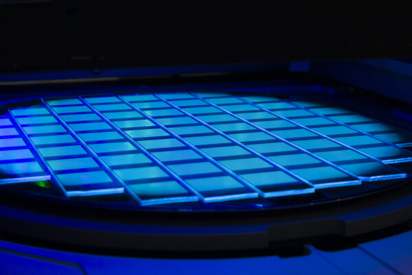 Silicon wafer with chips lightinhg in neon light.