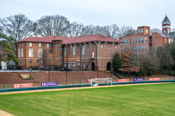 A university building situated near a university athletics field.