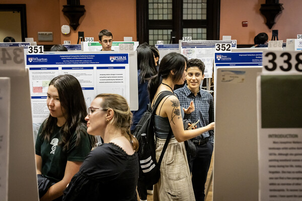 Students discussing their posters at the CURF poster expo.