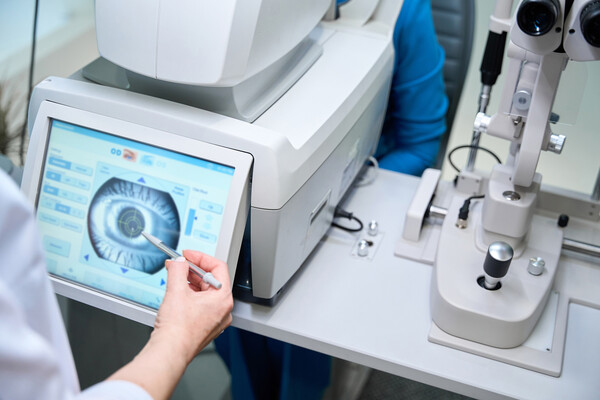 An opthamologist looking at a scan of an eye.