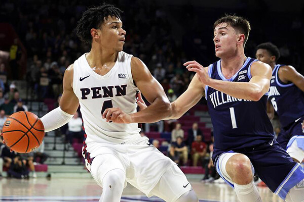 First-year guard Tyler Perkins, against Villanova at the Palestra, makes a move with the ball while guarded by a Wildcat defender.