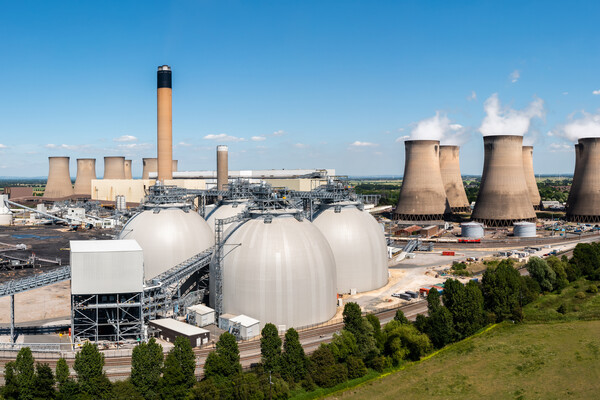 Aerial landscape view of a large coal fired power plant with storage tanks for Biofuel burning instead of coal