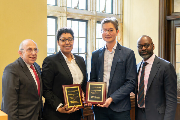 Ira Harkavy, Paulette Branson, Andy Tan, and John L. Jackson Jr. pose together at an award ceremony. Branson and Tan both hold plaques.