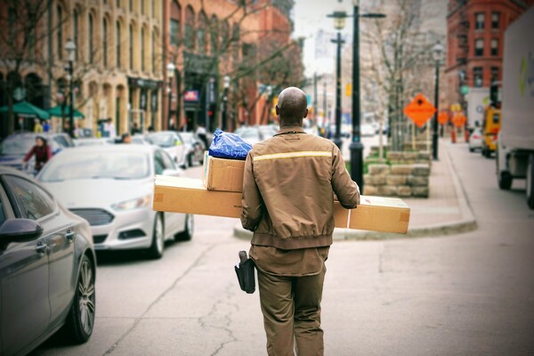 Man walking through a city carrying packages