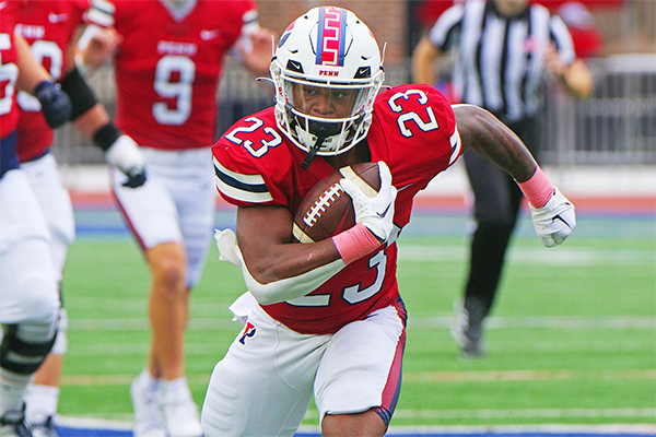 During a game at Franklin Field, Malachi Hosley runs down the field with the ball.