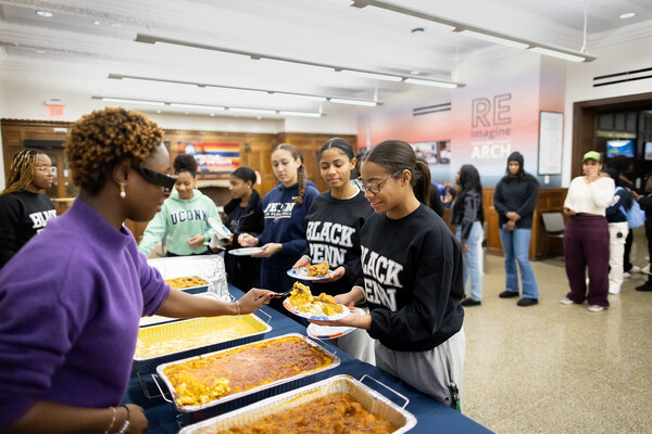 Students line up to receive food after the Kwanzaa ceremony