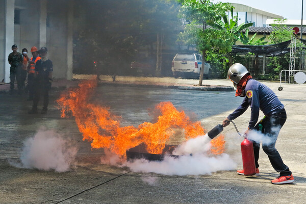  People preparedness for fire drill and training to use a fire safety tank.