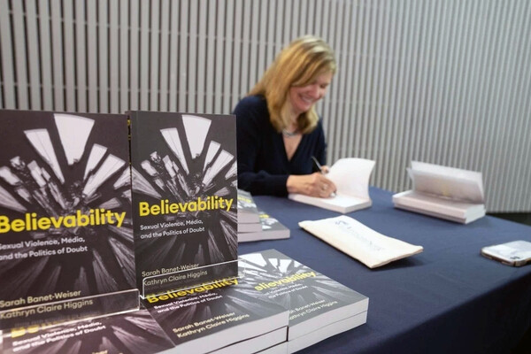 Sarah Banet-Weiser signs copies of the book she co-authored, “Believability.”