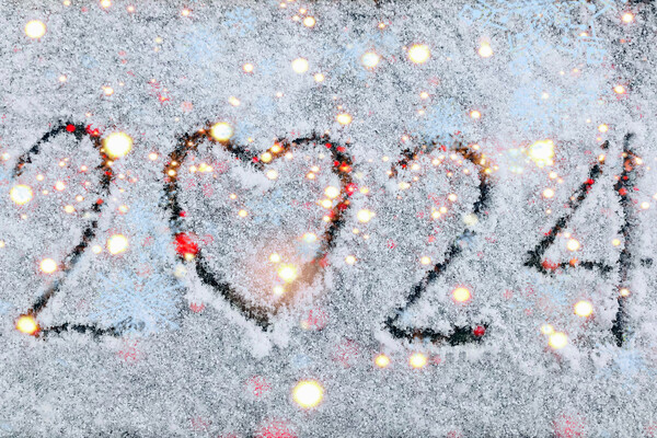 The year 2024 written in the snow with a heart for a zero.