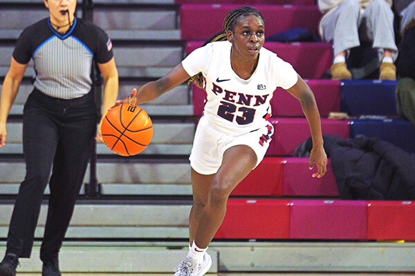 Ese Ogbevire dribbles the ball up the court during a game at the Palestra.