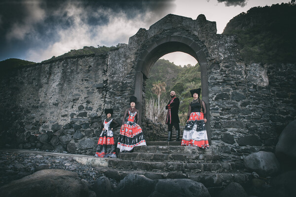 Dakhabraka posing by stone archway.