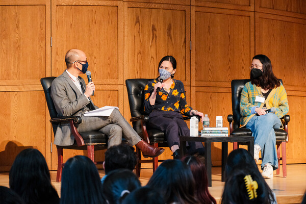 Three people sitting on a stage discussing books