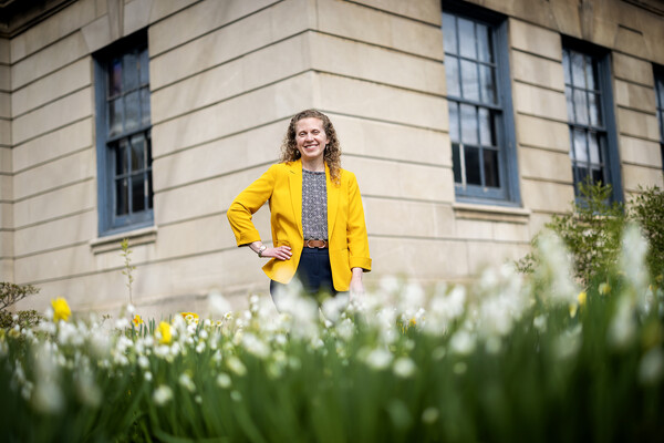 Kristyn Palmiotto posing among flowers.