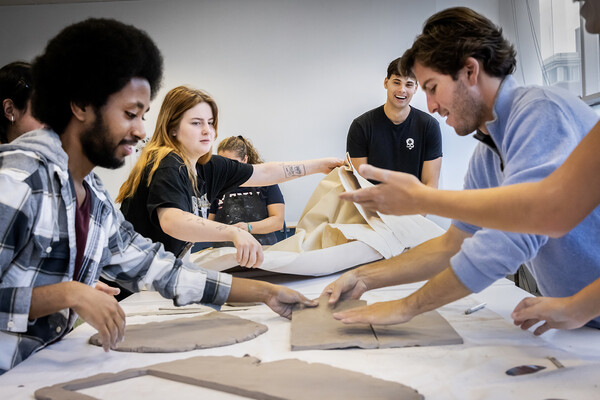 students working with clay slabs at a table