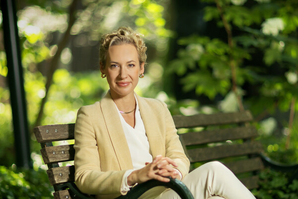 Brigitte Weinsteiger sits with hands crossed on a park bench