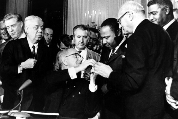 president johnson with martin luther king, jr signing civil rights act