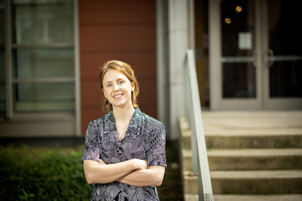 Katherine Scahill poses with her arms crossed in front of the Lerner Centeron Penn's campus.