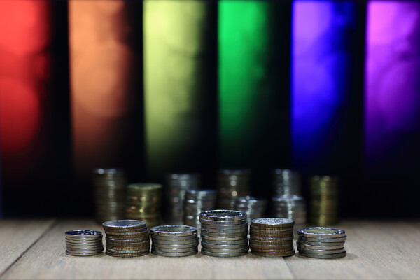 Coins placed in front of threads of rainbow.