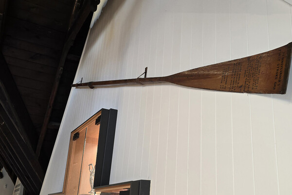 rowing oar mounted on the wall of Penn Boathouse