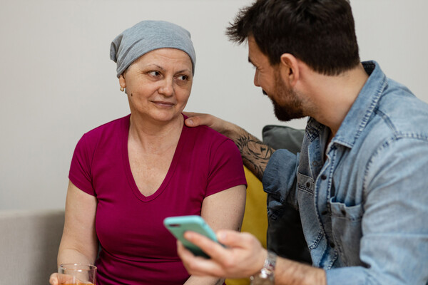 A cancer patient being comforted by a family member.