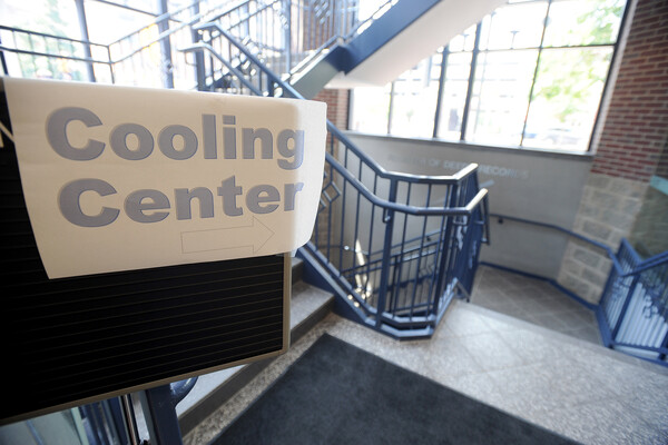 A sign in a stairwell pointing the way to a cooling center.