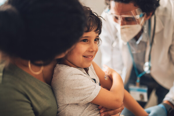 A young child getting a vaccine.