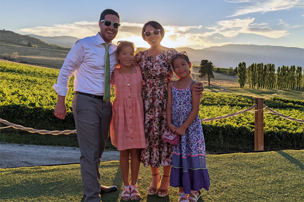 Becky Yu with her husband and children in a vineyard.