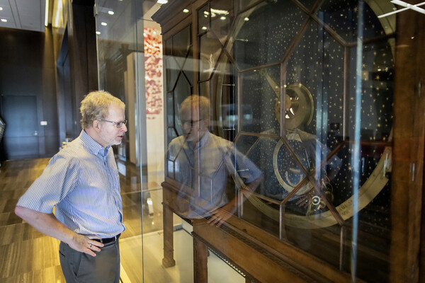 John Pollack standing in front of Rittenhouse Orrery