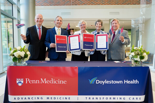 Kevin Mahoney and four others celebrate signing a contract between Penn Medicine and Doylestown Health.