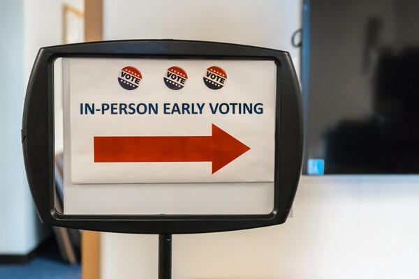 Sign that says 'IN-PERSON EARLY VOTING' with arrow