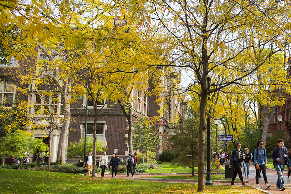 Students walking on Penn’s campus in the fall.