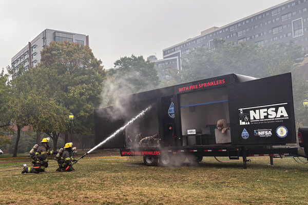 Firefighters put out a controlled burn of a dorm room replica on Penn’s campus during DPS’s controlled burn event.