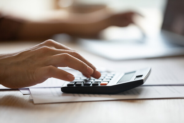 Hand using a calculator.