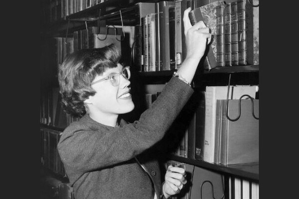 Elizabeth Brown shelving books in a library.