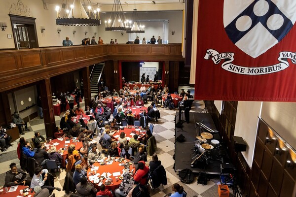 An image of the Hall of Flags looking down at round tables crowded with people