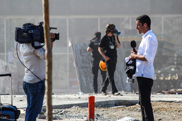 A news reporter reporting on the scene in Istanbul.