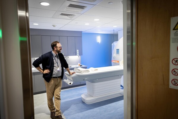 Brock Kirwan next to MRI scanner.