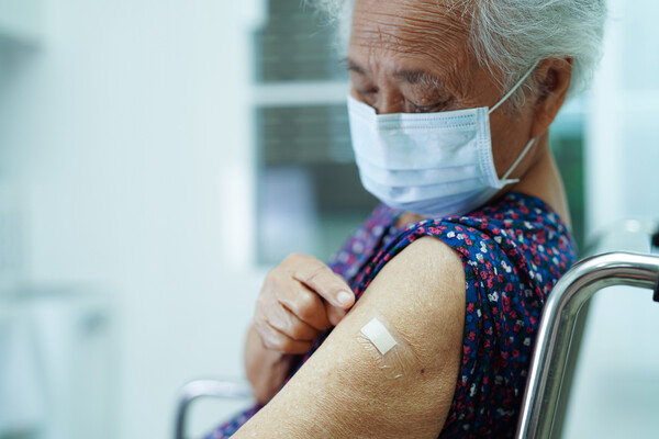 An elderly person who received a vaccine.