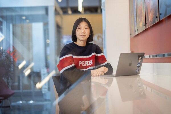 Rachel Liu sitting at a counter with her laptop.