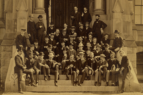 43 people sitting and standing on the steps of College Hall