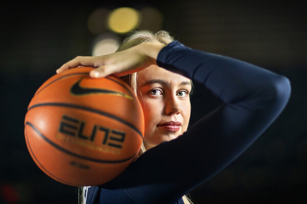 Stina Almqvist poses with a ball resting on her shoulder.