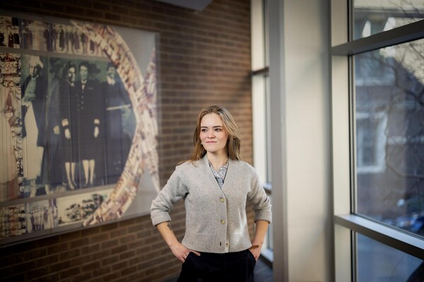 Charlotte Brown in front of historic nursing photo display.