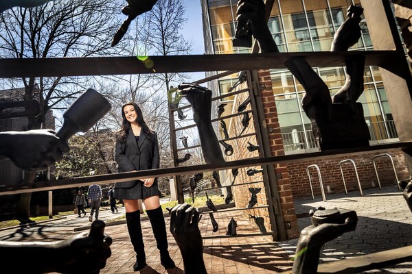 Thea Kerekes stands in front of Kelly Family Gates at Penn.